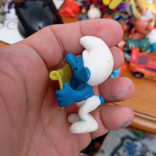 Smurf figure used reading a book