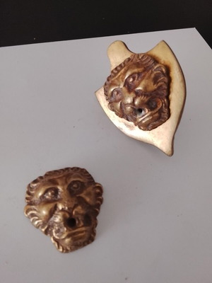 Small decorative brass lions used, about 3 centimeters