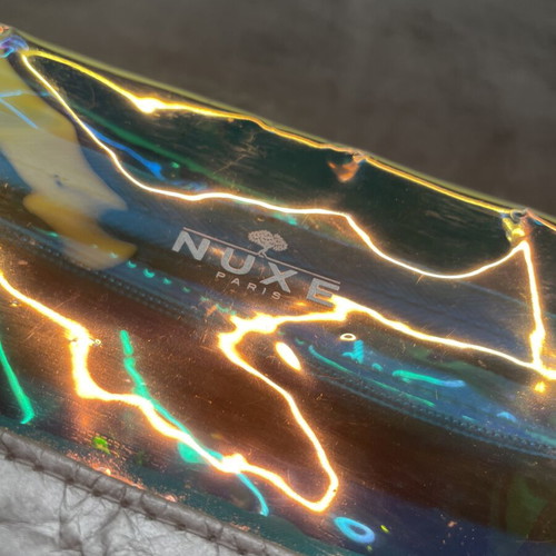 Nuxe holographic makeup bag with silver base