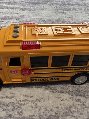Yellow school bus toy with realistic sounds and pull-back mechanism used