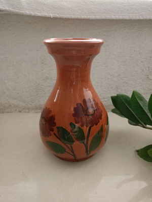 Traditional clay vase used, hand-painted with flowers