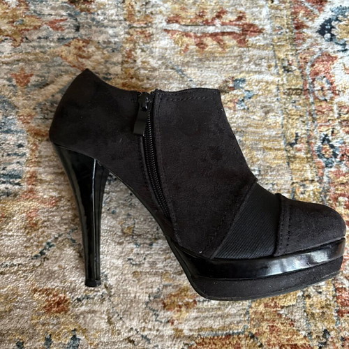 Adam’s black high-heeled shoes like new
