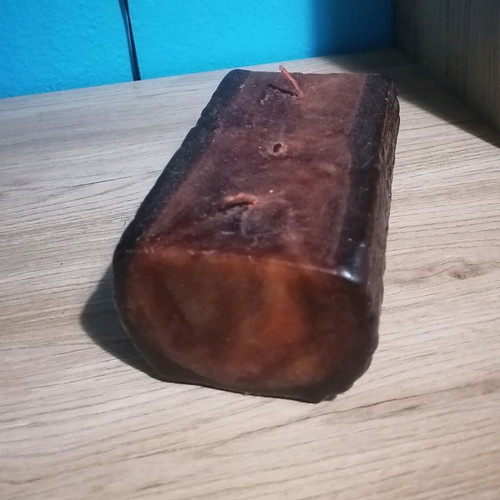 Handmade candle in wood log shape like new