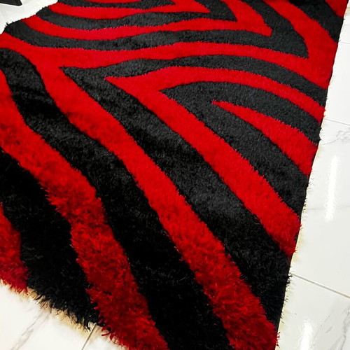 Shaggy 3D rug like new with three-dimensional wavy red and black design