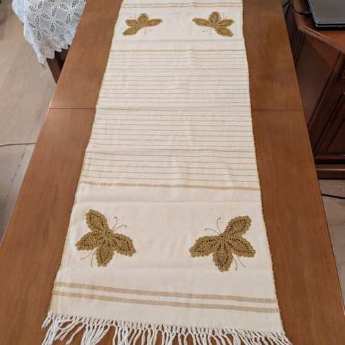 Set of three table linens with handmade golden knitted butterfly, used