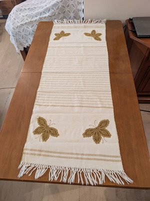 Set of three table linens with handmade golden knitted butterfly, used