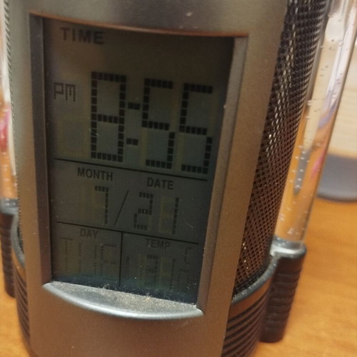 Pen holder with built-in electronic clock used