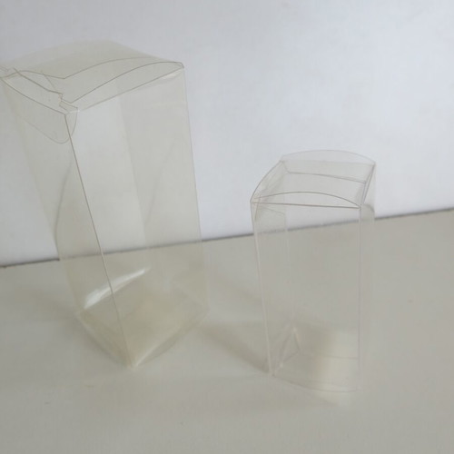Plastic transparent cases used for figures and Game Boy