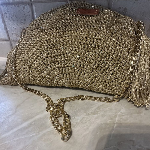 Handmade knitted shoulder bag in gold with decorative tassel