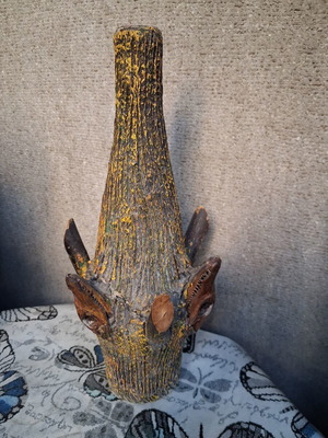 Vintage decorative glass bottle with animal heads, handmade folk art