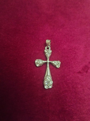Modern cross pendant with curved ends and synthetic stones