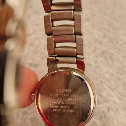 Casio women's watch used with black dial and metal bracelet