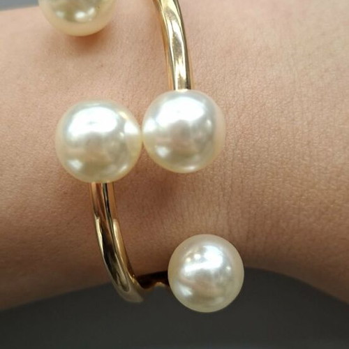 Gold tone bracelet with plastic pearls