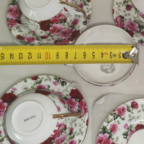Vintage porcelain tea cups set with floral rose pattern and lithophany