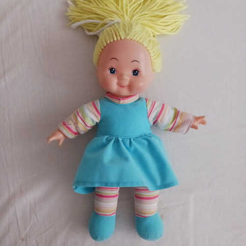 Doll with blonde yarn hair like new, soft body