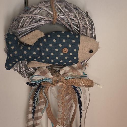 Handmade fabric fish decoration on white rattan wreath