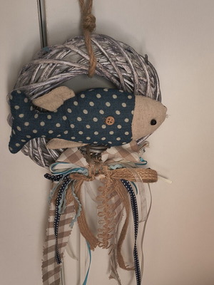 Handmade fabric fish decoration on white rattan wreath