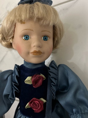 Porcelain doll like new vintage with blue satin dress