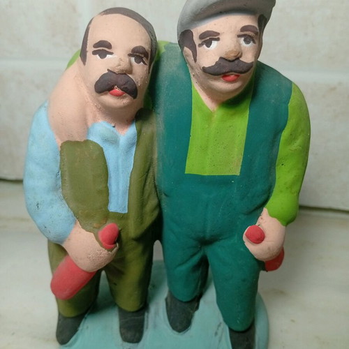 Ceramic figure of two men with traditional costumes like new