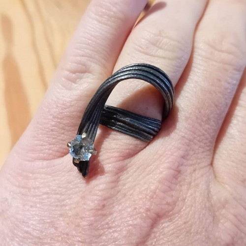 Handmade ring of oxidized silver with white topaz like new