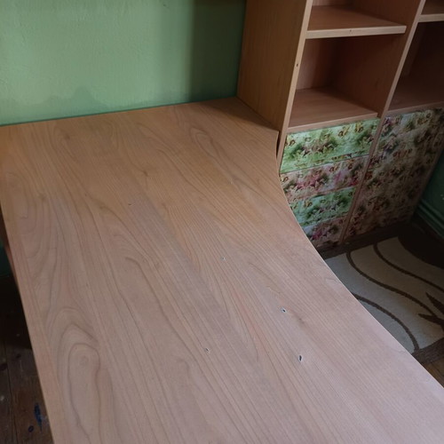 Desk with bookshelf and multiple storage spaces used