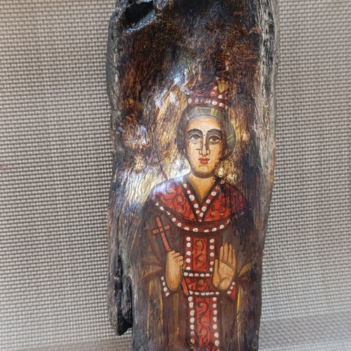 Old religious icon on wood trunk, handmade