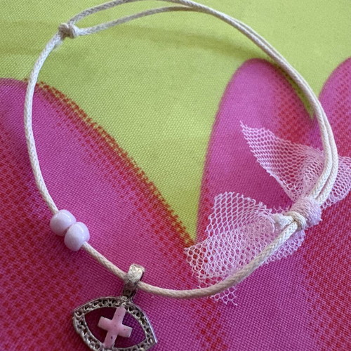 Adjustable cord bracelet with metal eye and pink cross