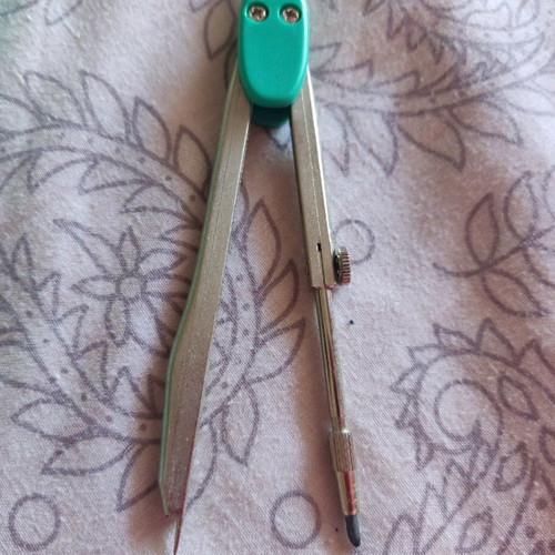 School compass used with pencil tip and extra replacement