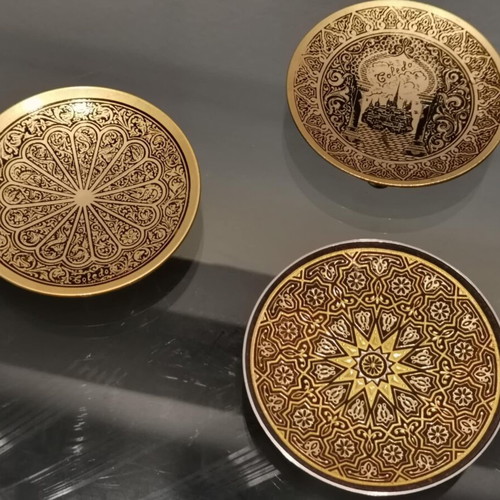 Set of three used metal candle holders with Arabic designs