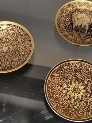 Set of three used metal candle holders with Arabic designs