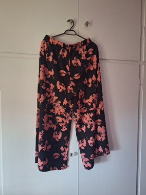 Pants new, black with pink flowers, sizes L and XL