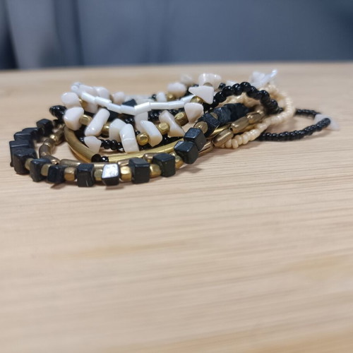 Set of elastic bracelets with assorted beads in black, white and gold