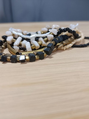 Set of elastic bracelets with assorted beads in black, white and gold