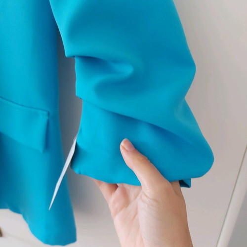 Blue jacket new with unique sleeve and tags