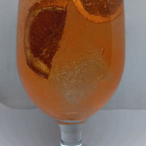 Handmade candle in Aperol Spritz glass with Aperol Spritz scent
