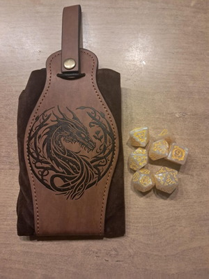 Brown leather dragon dice bag with white D&D dice