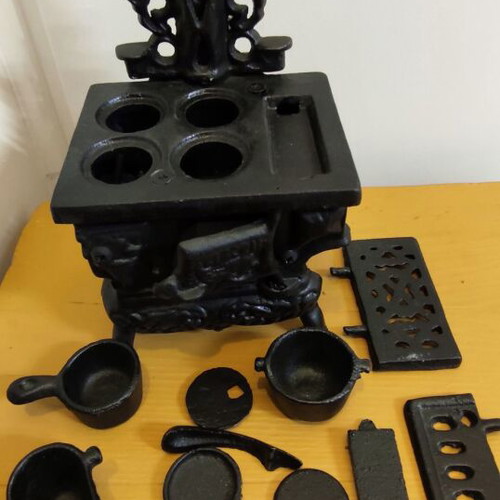 Miniature wooden stove with cast iron accessories like new