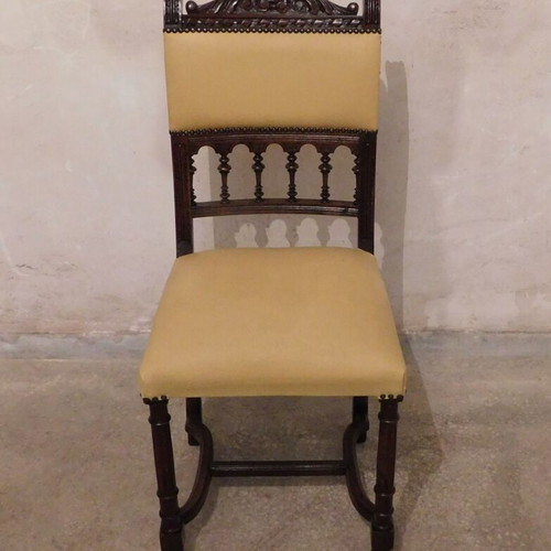 Wood-carved chair with leather seat like new, about 100 years old