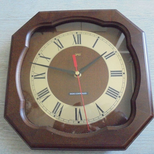 Wall clock radio controlled used with wooden frame and Roman numerals