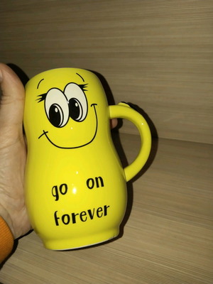 Yellow mug used with smiling face design