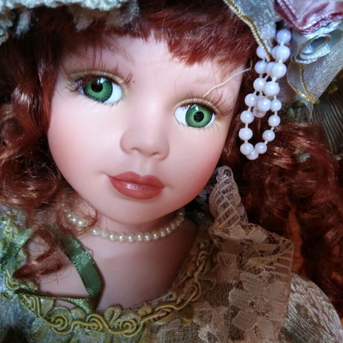 Porcelain doll with green eyes like new