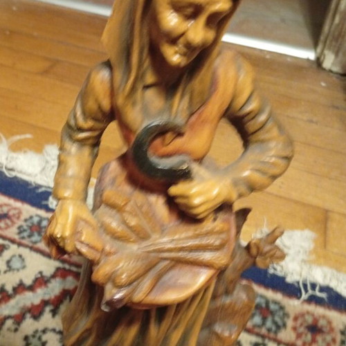 Vintage folk art decorative figurine of elderly peasant harvesting