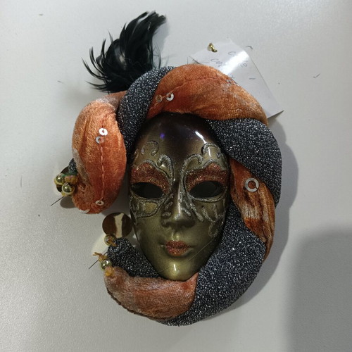 Decorative wall mask used, orange and silver shades