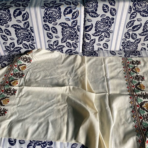 Woven fabric on loom new, thin cream wool textile with embroidery
