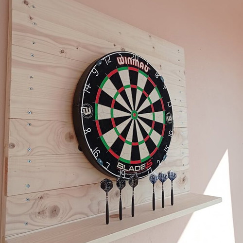 Winmau Blade 5 dartboard used with darts and wooden backing