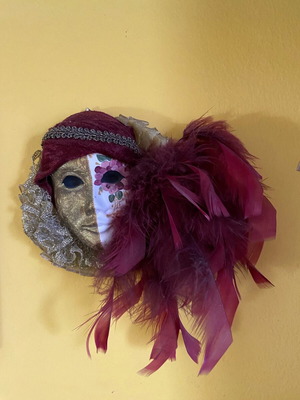Venetian style decorative ceramic mask used with feathers