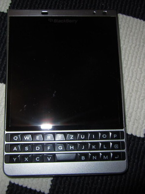 BlackBerry Passport Silver Edition used, no signal, broken back cover
