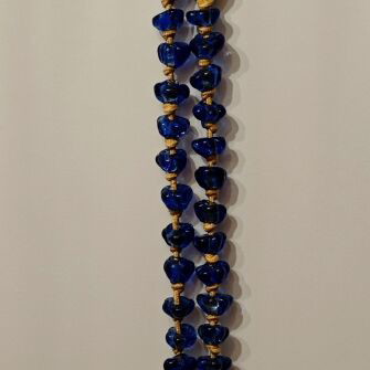Tabletop komboloi with blue and gold glass beads