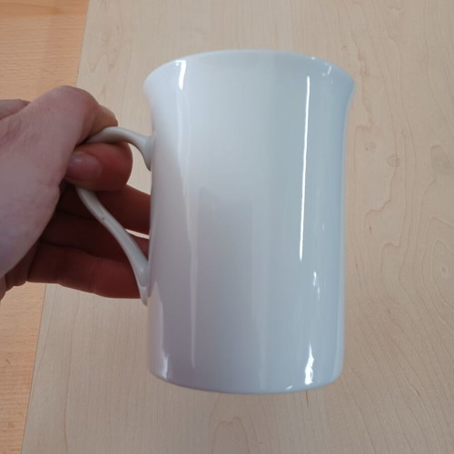 Ceramic white cylindrical mug used