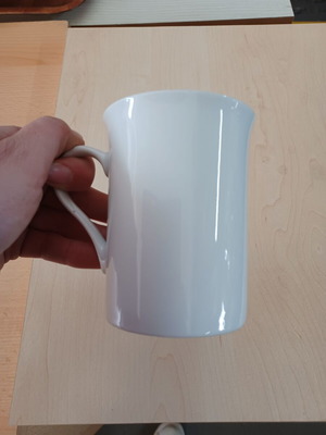Ceramic white cylindrical mug used